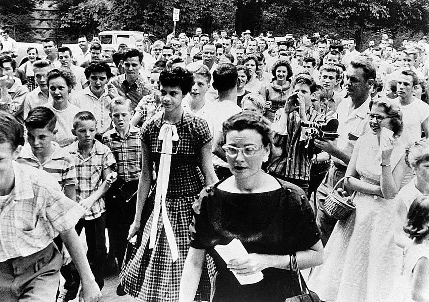 She was met by hostile crowds of students and adult members of the local White Citizen Council who taunted her, spit on her, and pelted her with sticks and pebbles.