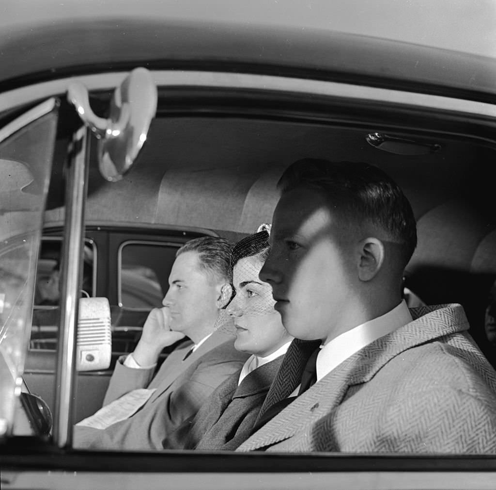 A trio of worshippers sit in their automobile during the Sunday Service at the Drive-In theatre, 1955