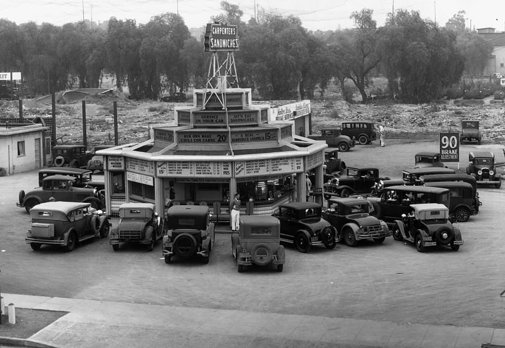 A busy parking lot around Carpenter's Sandwiches drive in restaurant.