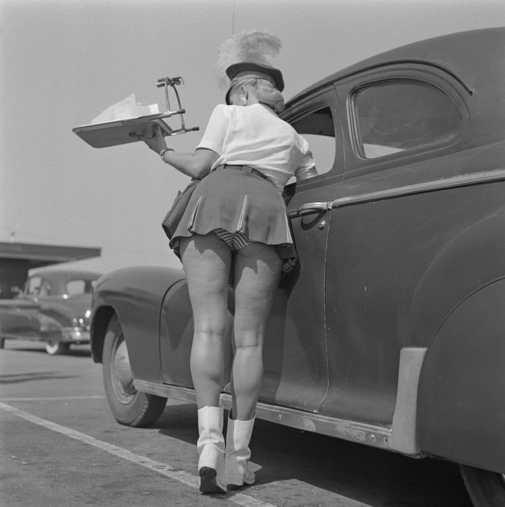A waitress or carhop at The Clock Drive-In restaurant in California, 1955.