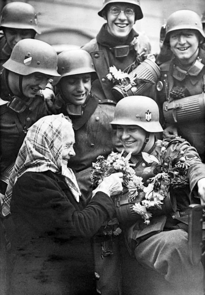 People welcoming the occupying German troops in the Sudetenland region of Czechoslovakia, October 3, 1938.