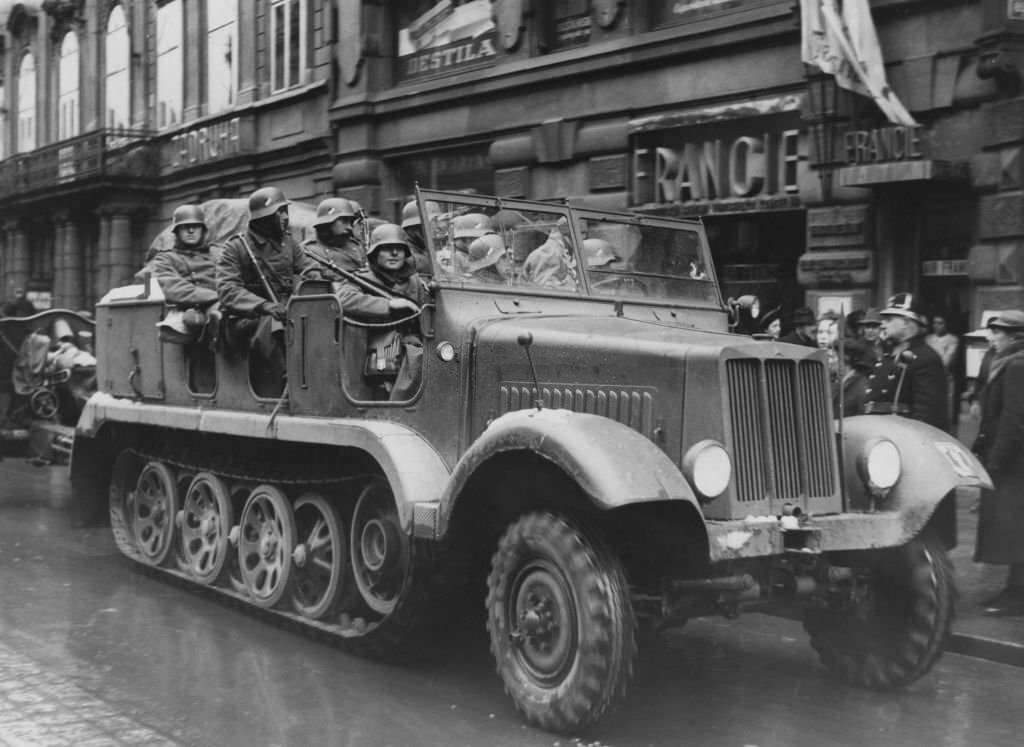 German troops enter Prague in Czechoslovakia, at the beginning of the German occupation, 1939. On the right is a Czech police officer.