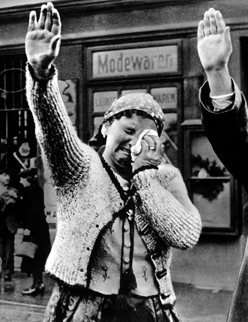 A woman in the Sudetenland greets incoming German troops with tears and a German Salute.