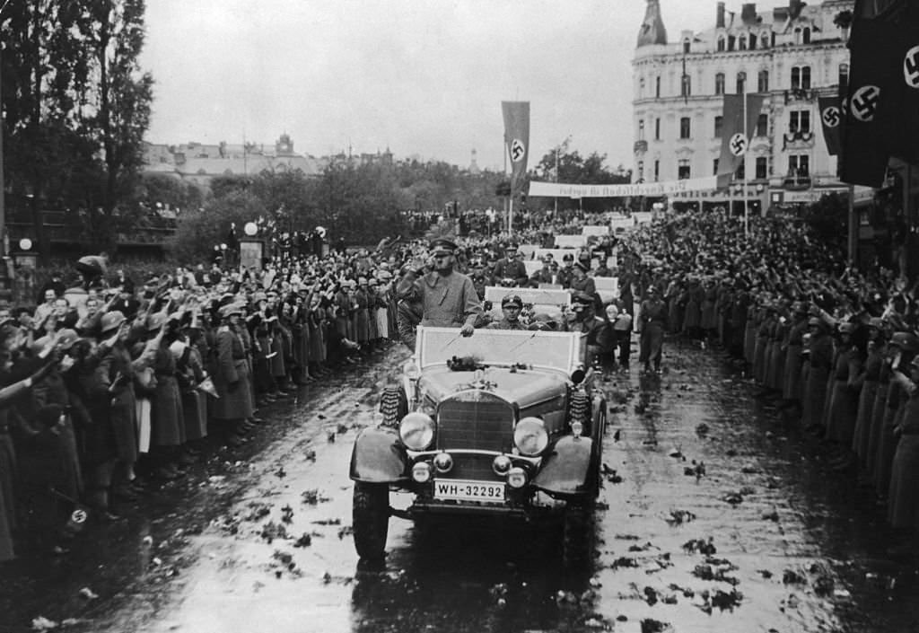 Adolf Hitler is welcomed by crowds lining the streets of Carlsbad (now Karlovy Vary) in the Sudetenland, Czechoslovakia, after the annexation of the territory into the German Reich, 6th October 1938.
