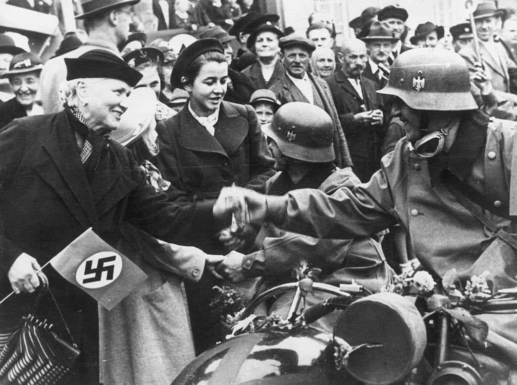 Ethnic Germans living in the Sudetenland in Czechoslovakia welcome the German troops who have arrived to annex the region under the terms of the Munich Pact.