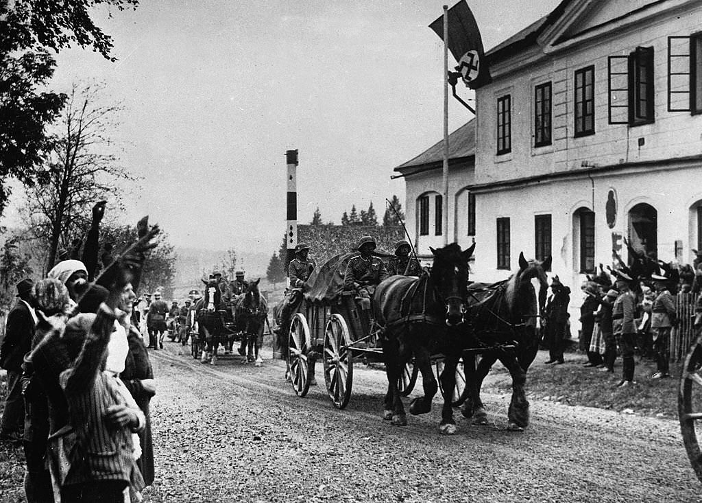 German soldiers making their way through a street in the Sudetenland part of Czechoslavkia during the invasion and occupation of the country prior to World War Two