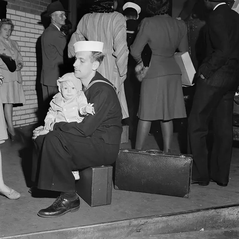 A sailor and child wait for a Greyhound in Memphis.