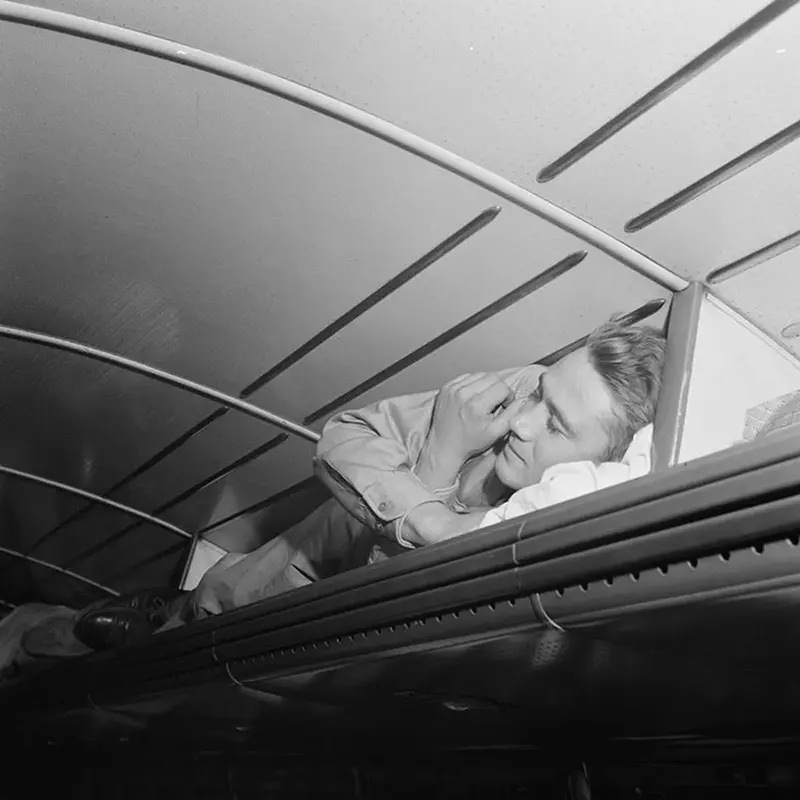 A soldier sleeps in a luggage rack on a bus from Cincinnati to Louisville.