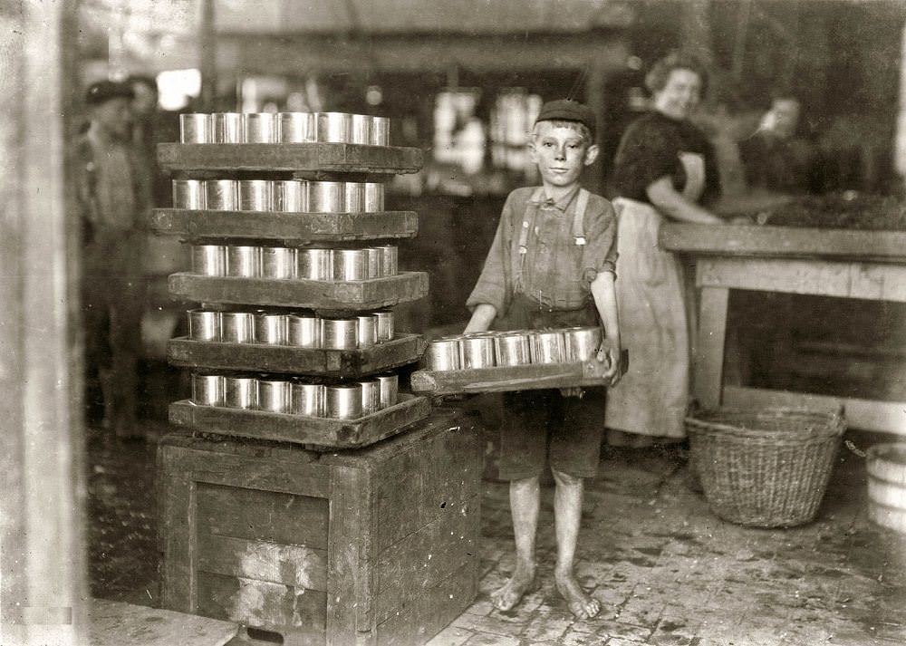 One of the small boys in J.S. Farrand Packing Co. and a heavy load, Baltimore, 1909