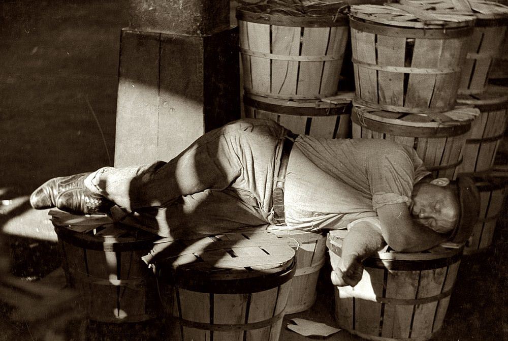 Man sleeping in the Baltimore fish market, July 1938
