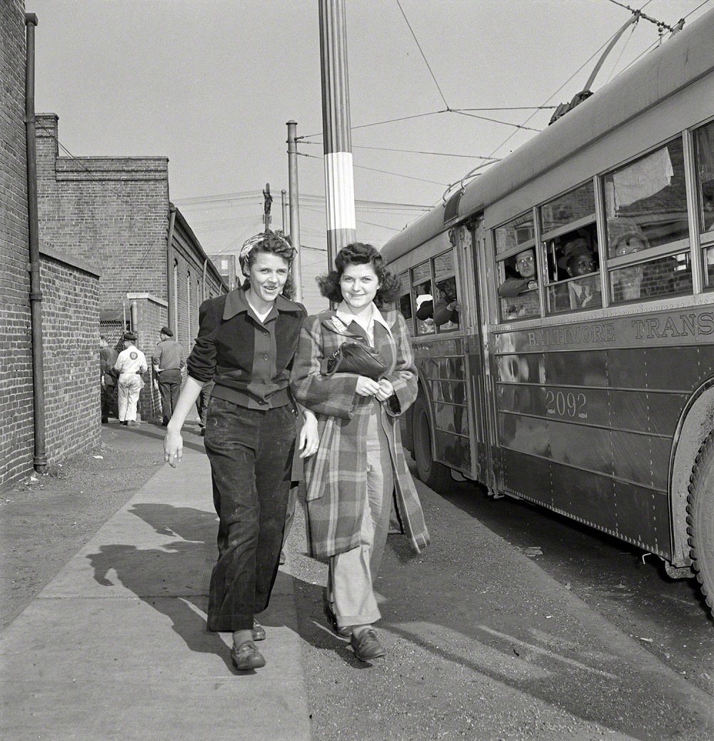 Two women rushing to catch the trackless trolley, Baltimore, April 1943