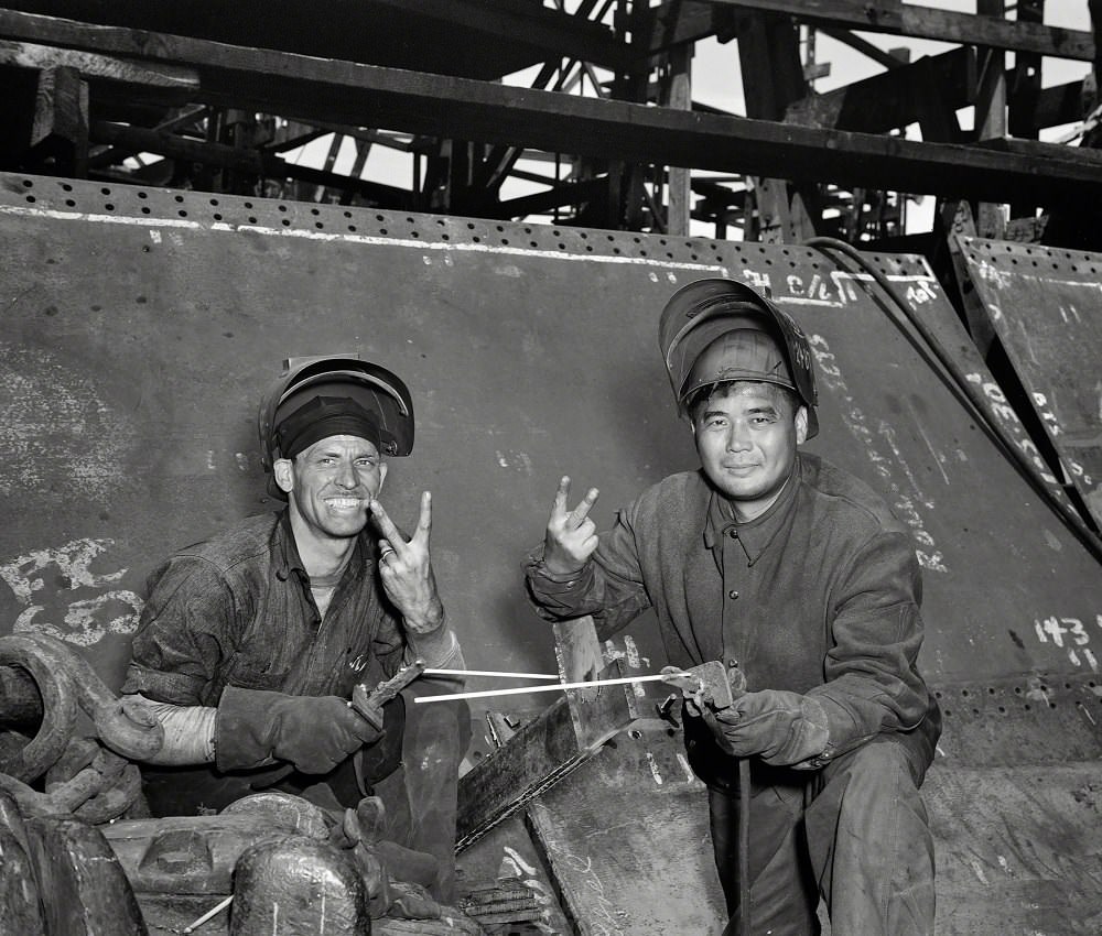 Electric welders working on the Liberty ship Frederick Douglass at the Bethlehem-Fairfield shipyards, Baltimore, Maryland, May 1943