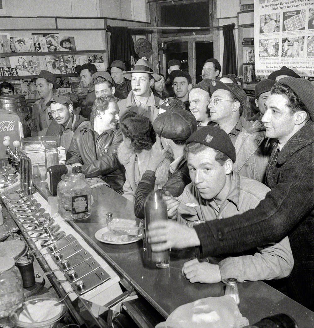 Third-shift defense workers getting snack at drugstore, Baltimore, April 1943