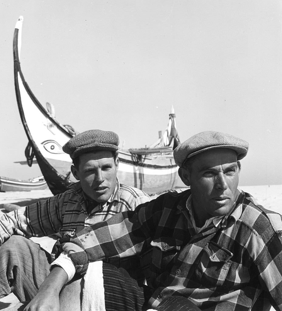 Portuguese fishermen relax on the beach at Nazare, 1952