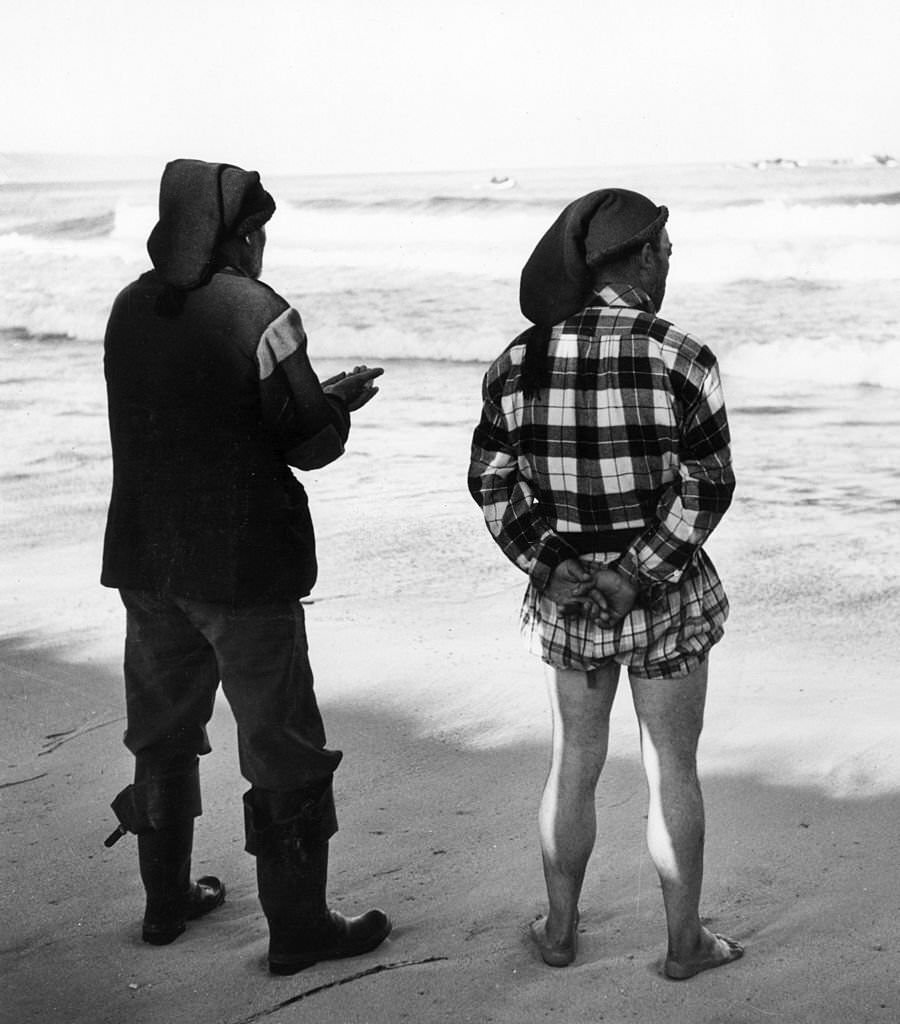 Two fishermen from Nazare in Portugal prepare for the day's fishing.