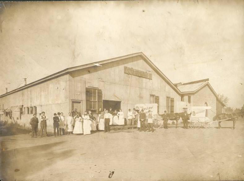 Horse-drawn vehicles and employees outside the Kelley Laundry building, 1900s