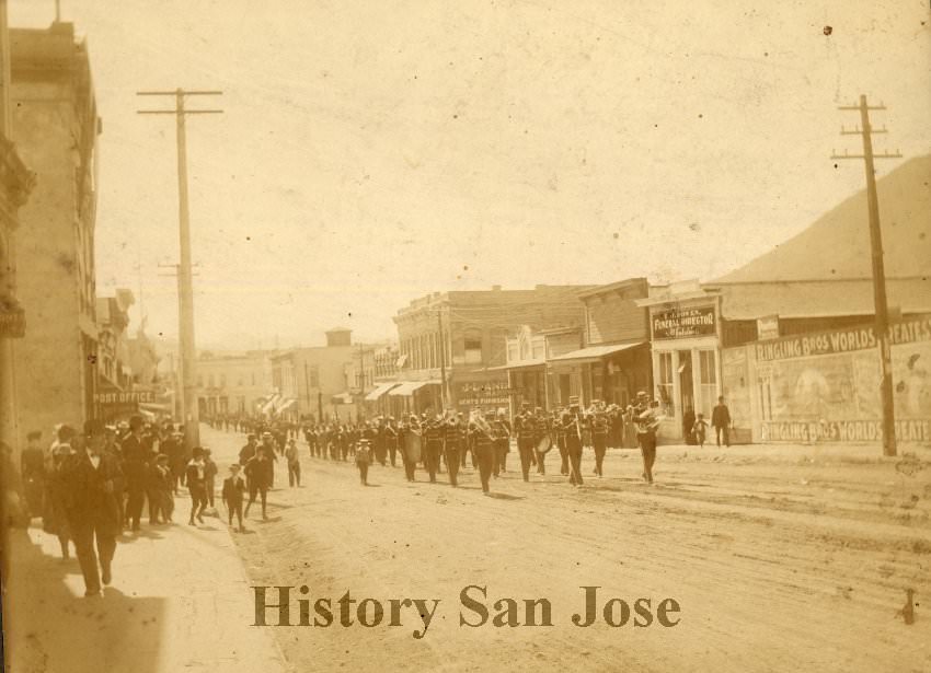 Marching band parading in the street, 1890