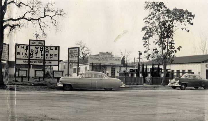 Car in front of Holy City buildings, 1950