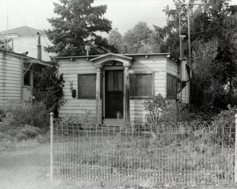 Small building surrounded by vegetation, 1940