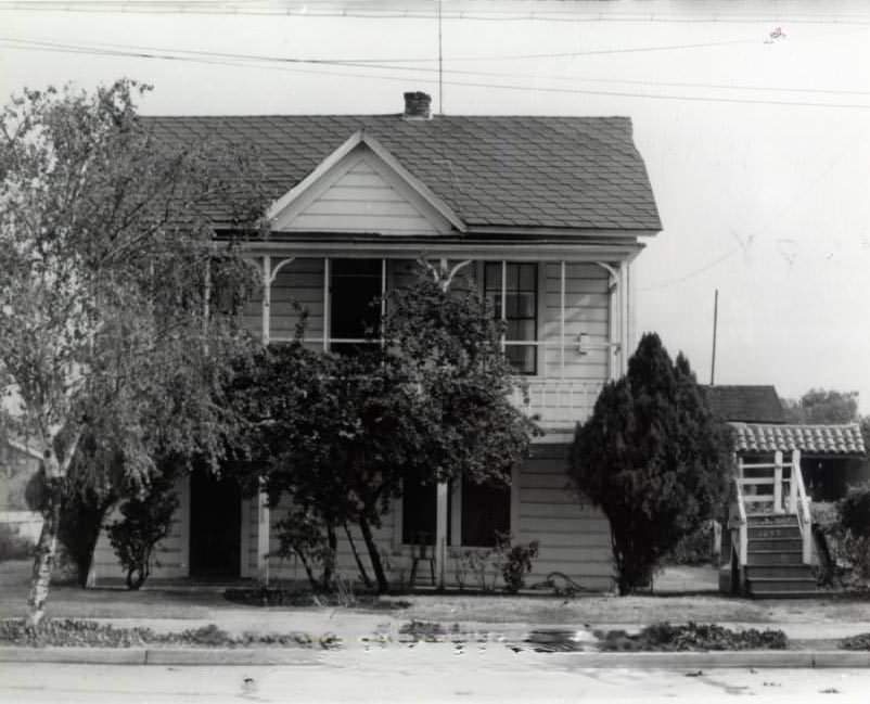 Two-story home surrounded by vegetation, 1940