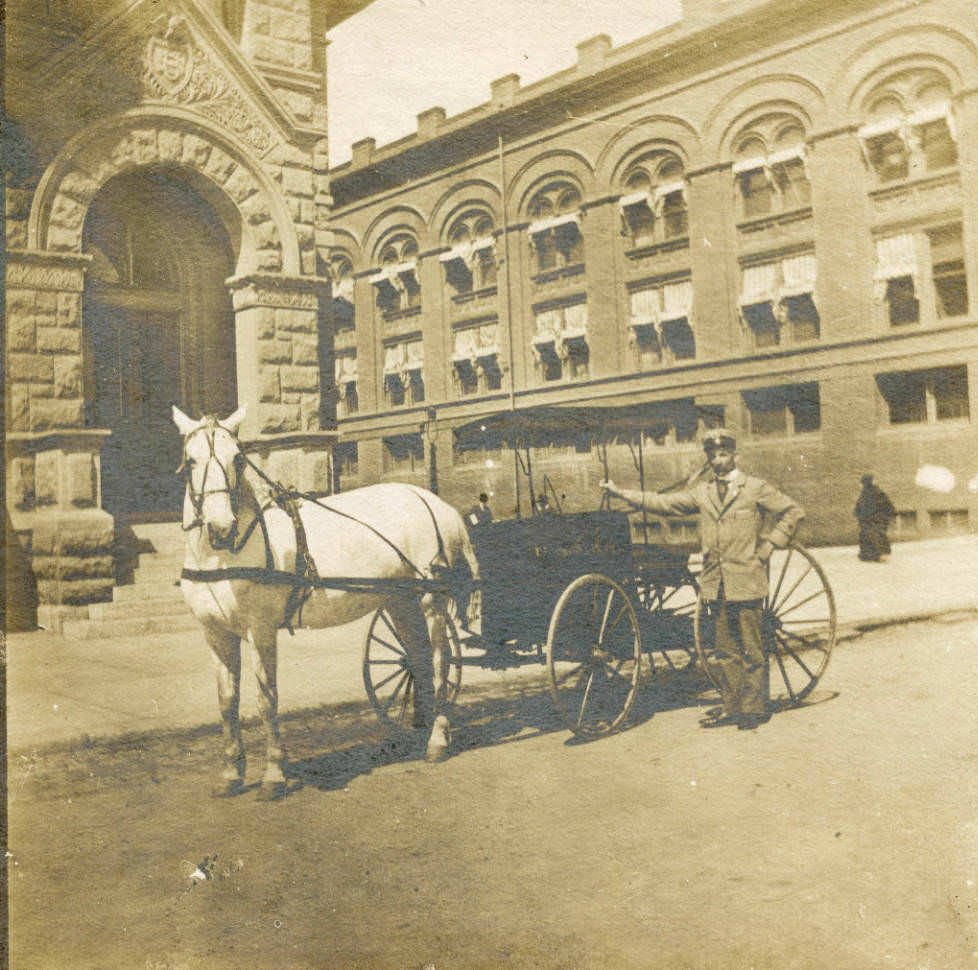 Gerhardus De Wit who served as one of San Jose's first mail carriers stands in front of his horse drawn carriage, 1900
