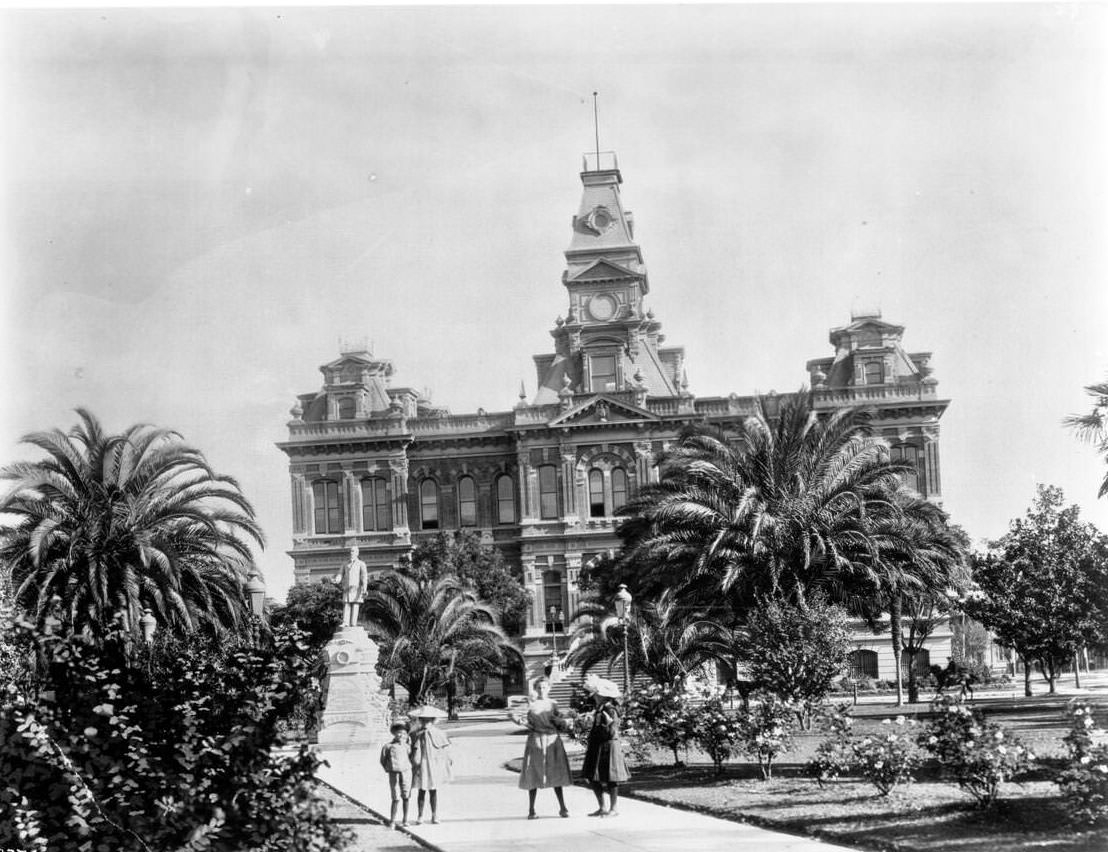 Four children posing in the courtyard in front of the San Jose City Hall, 1907