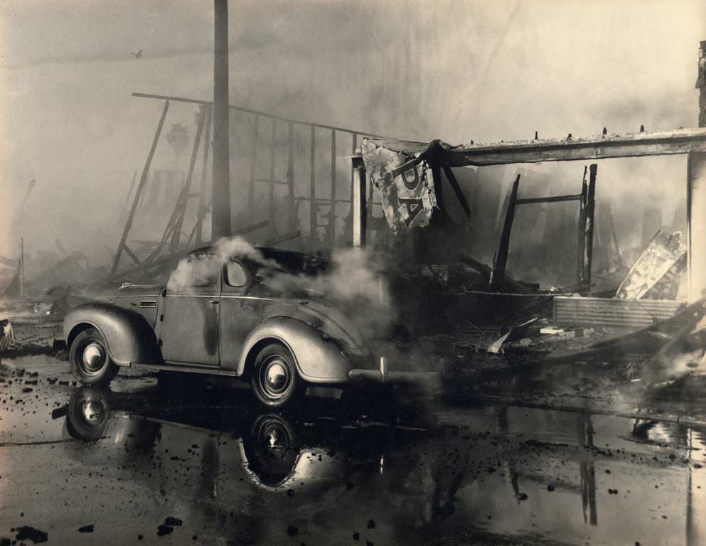 Automobile engulfed in billowing smoke, 1947