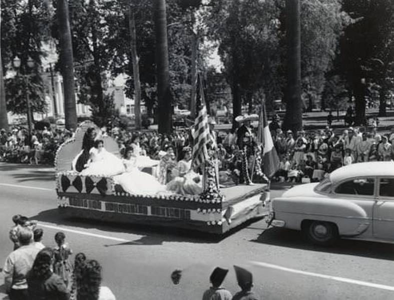 Parade float along Saint James Park, with lettering on the side, San Jose, 1950s