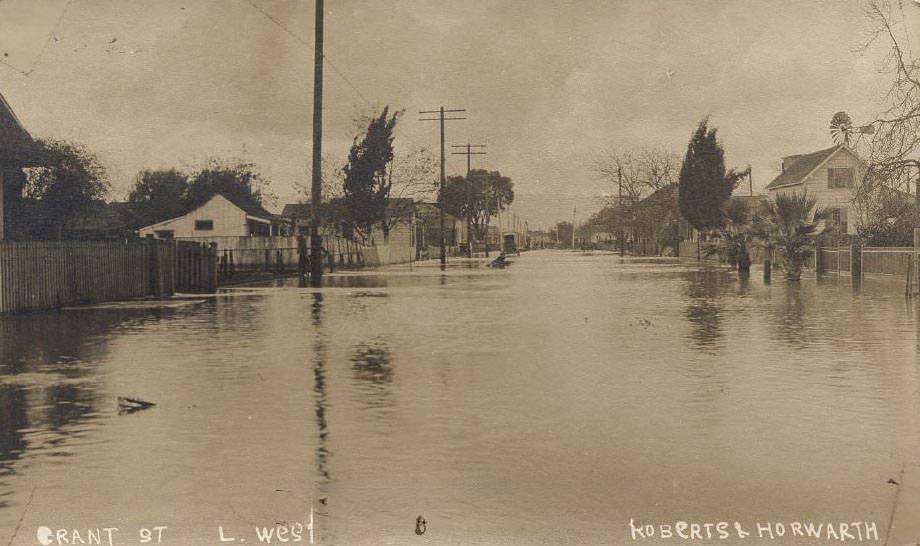 Near First Street, San Jose (California), sowing the standing water across the entire street, 1911