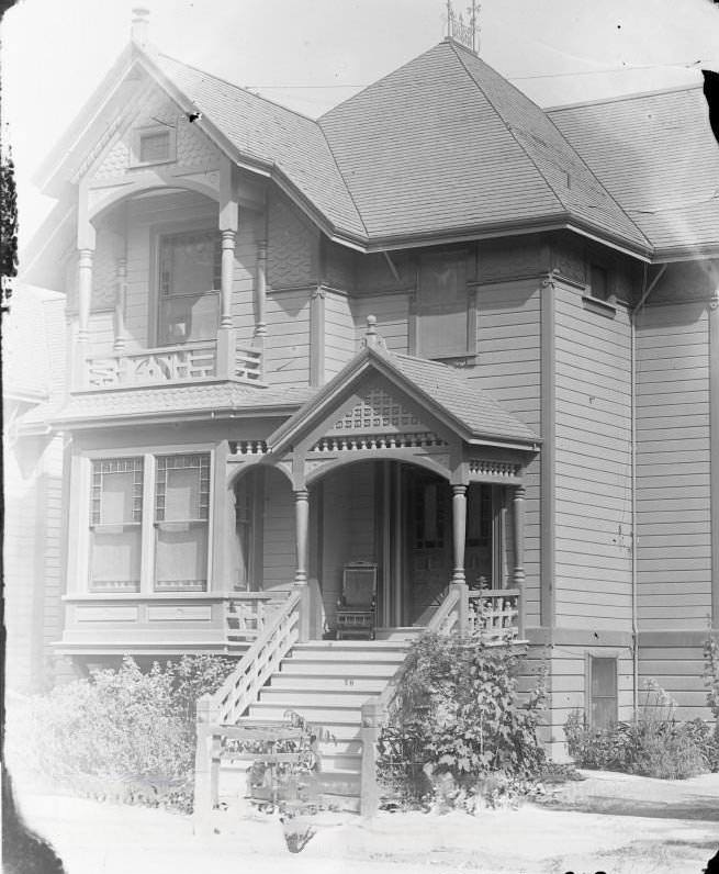 Victorian home on Julian Street with a rocker on porch, 1900s