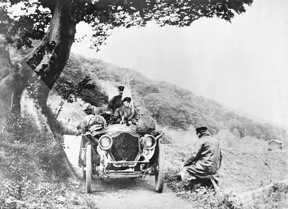 The American Thomas Flyer car drives through the Manchurian countryside.