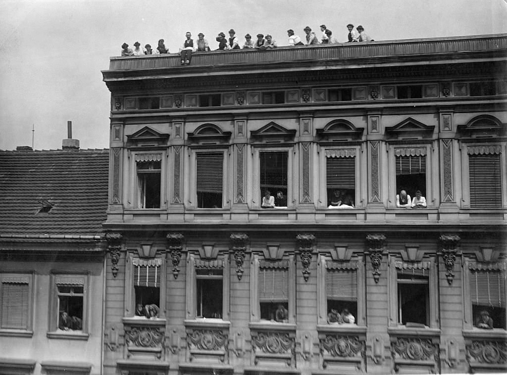 Viewer at rooftop. They would like to have a better look at the arriving racing cars.