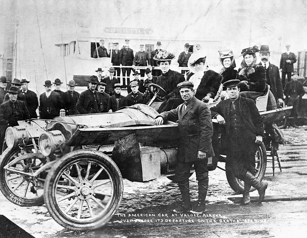 People surround the Thomas Flyer American car in the 1908 New York to Paris Auto Race, at Valdez, Alaska, while it waits for the ferry to cross to Siberia.