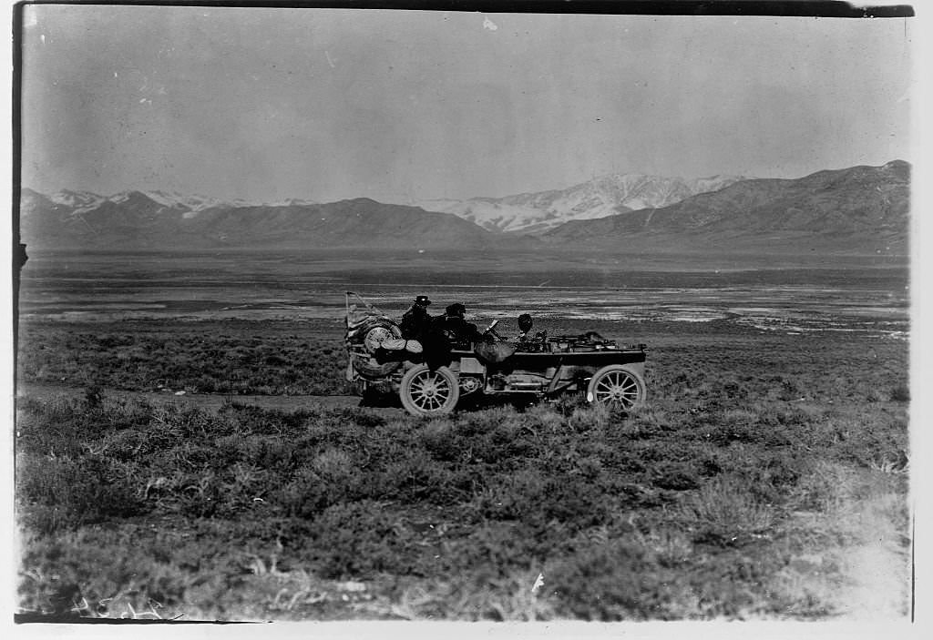 The American Thomas Flyer automobile drives through scrubland during the 1908 New York to Paris Auto Race.