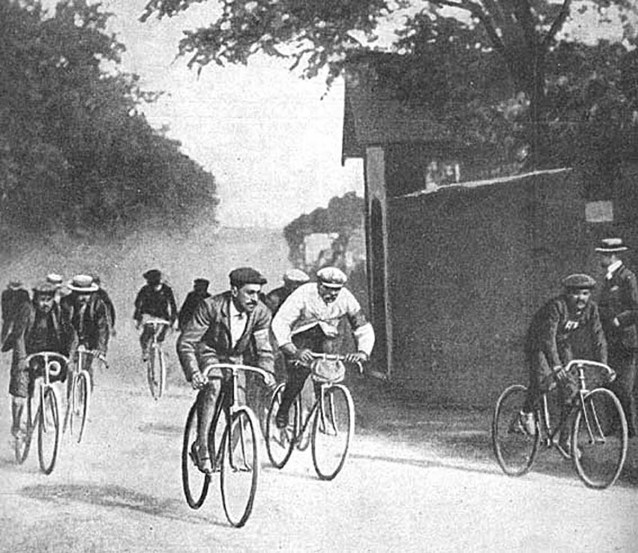 Maurice Garin, in his trademark white coat and flat cap racing in the 1903 Tour.