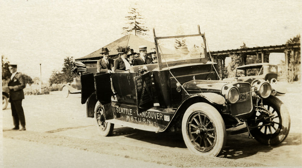 Three women and two men sit inside an open touring car, Vancouver, 1920