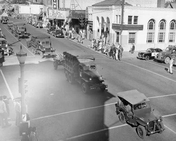 A line of military vehicles move down the street during the Cenaqua Parade on August 6, 1950 in Vancouver, Washington.