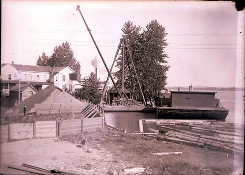 Dock scene on Vancouver's Waterfront with the Alta House in the background, 1880