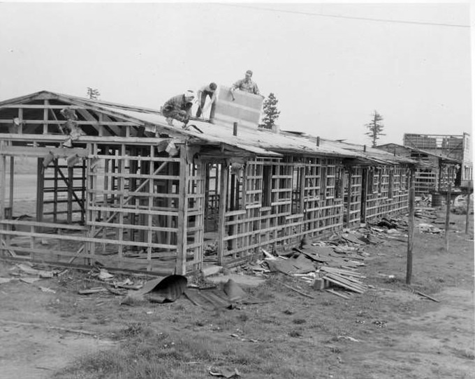 Men working on the demolition of a home. Vancouver Housing Authority, 1940s