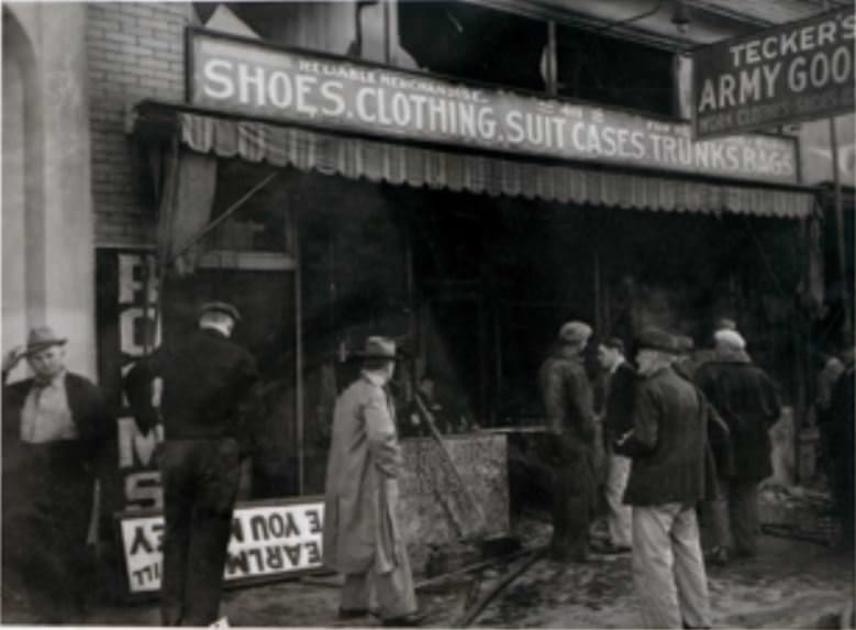 People inspect the damage caused by a fire at a army goods store in Vancouver, Washington, 1940