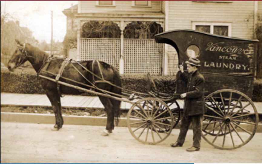 A man walks along side a horse drawn wagon advertising Vancouver Steam Laundry, 1890s