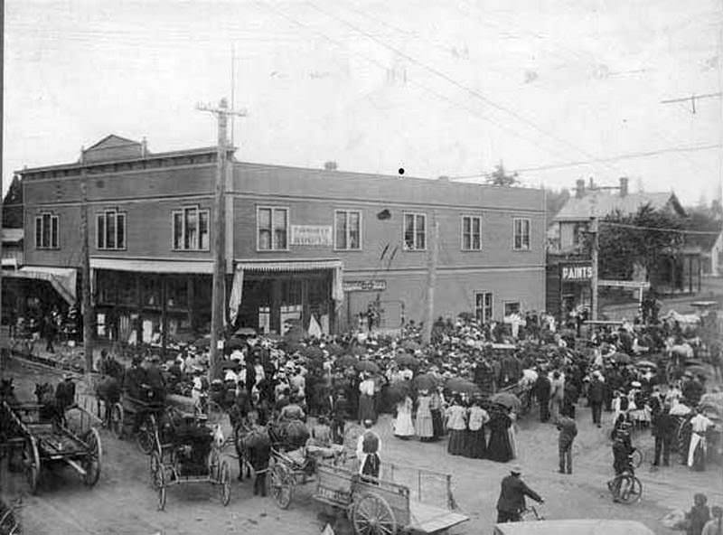 A event taking place at the Carter & Carter Store at 8th and Main in Vancouver. At left is the small store Great Western & Co, 1880s
