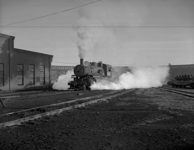 Northern Pacific engine 1254 leaves the roundhouse either in Vancouver, 1953