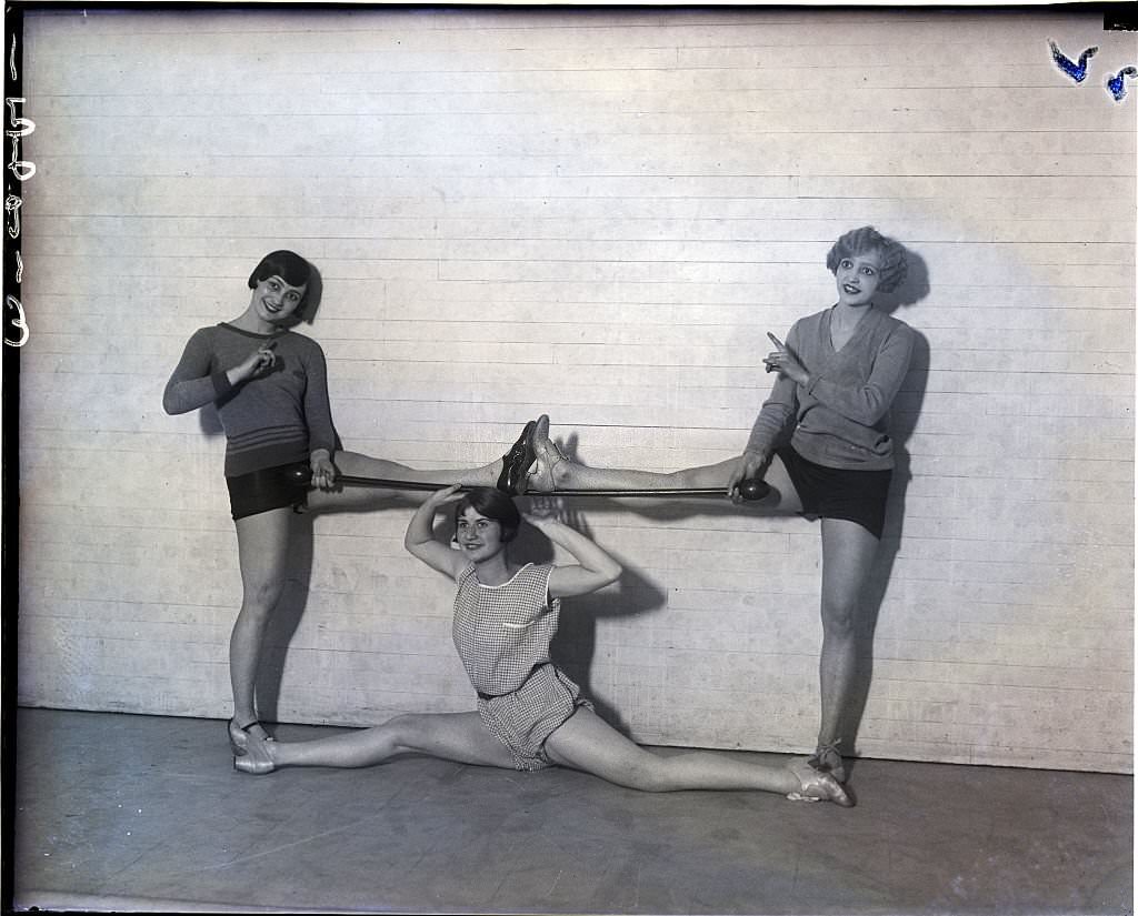 Three Women in Stretch-Pose in Gymnasium