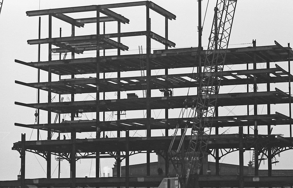 Silhouettes of construction workers .