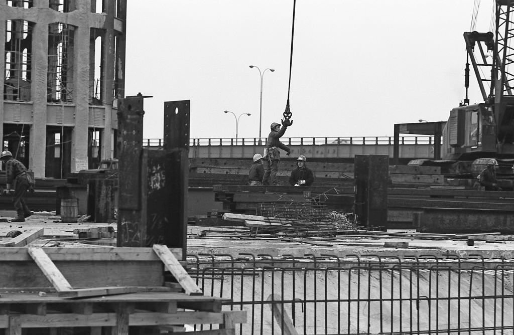 Construction workers secure a hook from a crane during construction of Towers One and Two of the World Trade Center in the Winter of 1970