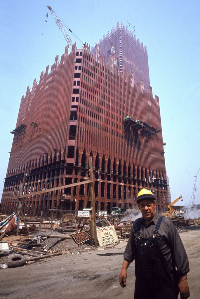 A construction worker walks past the emerging structure of the Twin Towers on the World Trade Center site in downtown New York, 1970.