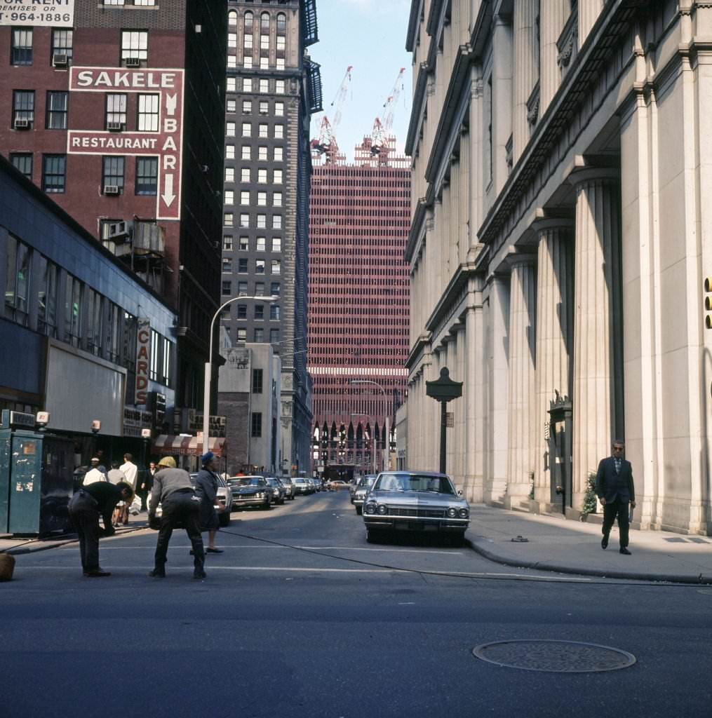 Looking west, along Dey Street (at Broadway) of the on-going construction of One World Trade Center (North Tower), 1969