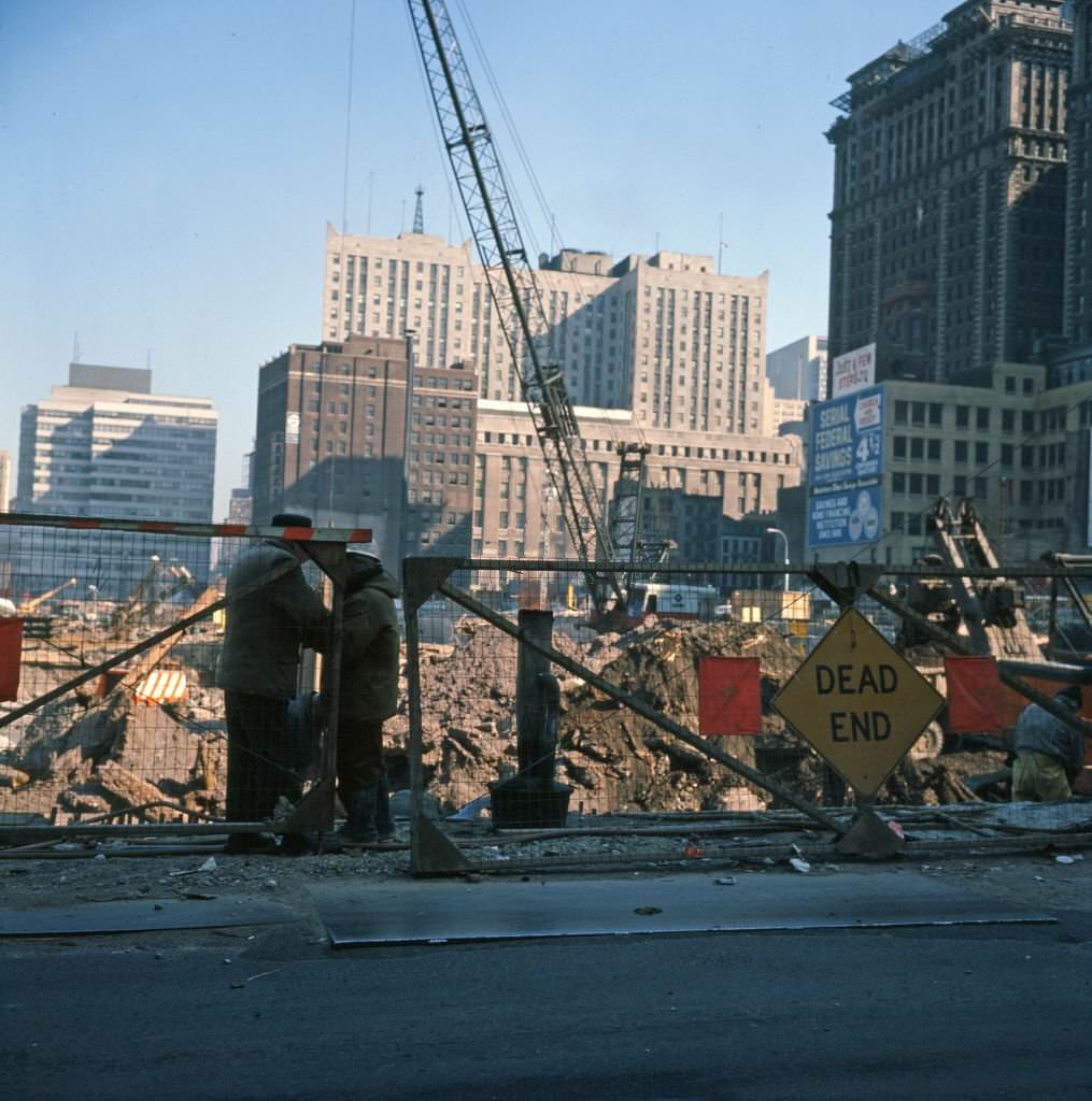 View of two men in front of the construction site for the World Trade Center complex, 1968. (