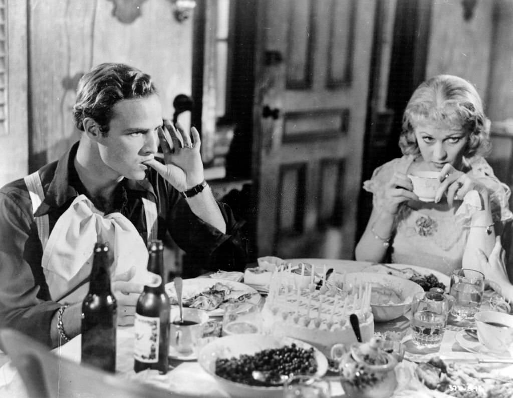 American actor Marlon Brando and Vivien Leigh celebrate a tense birthday as Stanley Kowalski and Blanche DuBois in 'A Streetcar Named Desire'.